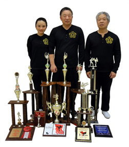 Amy & Matthew with Peter and their trophies.